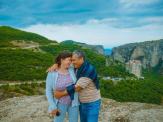 A couple hugging each other on the hill
