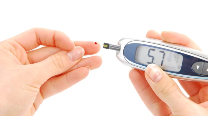 A person using blood sugar measure device