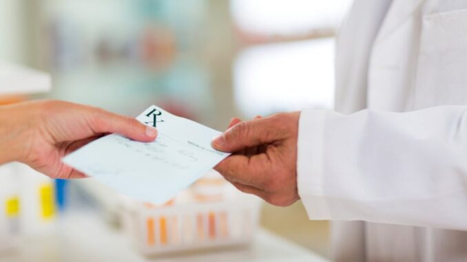 A doctor holding a prescription