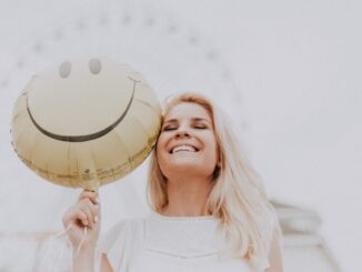 A smiling woman happy with balloon.