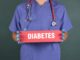 A doctor holding a banner with phase of "Diabetes"