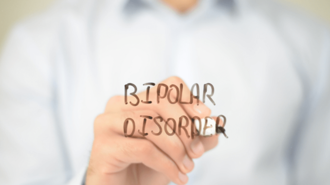 A man writing "Bipolar disorder" word