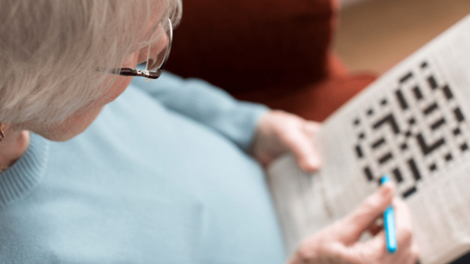 A senior woman playing puzzle