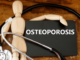 A dummy with stethoscope and the word of osteoporosis