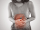 a woman holding her belly and the stomach image