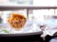 A bowl of mac and cheese and a spoon