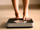 A person step on the weight scale